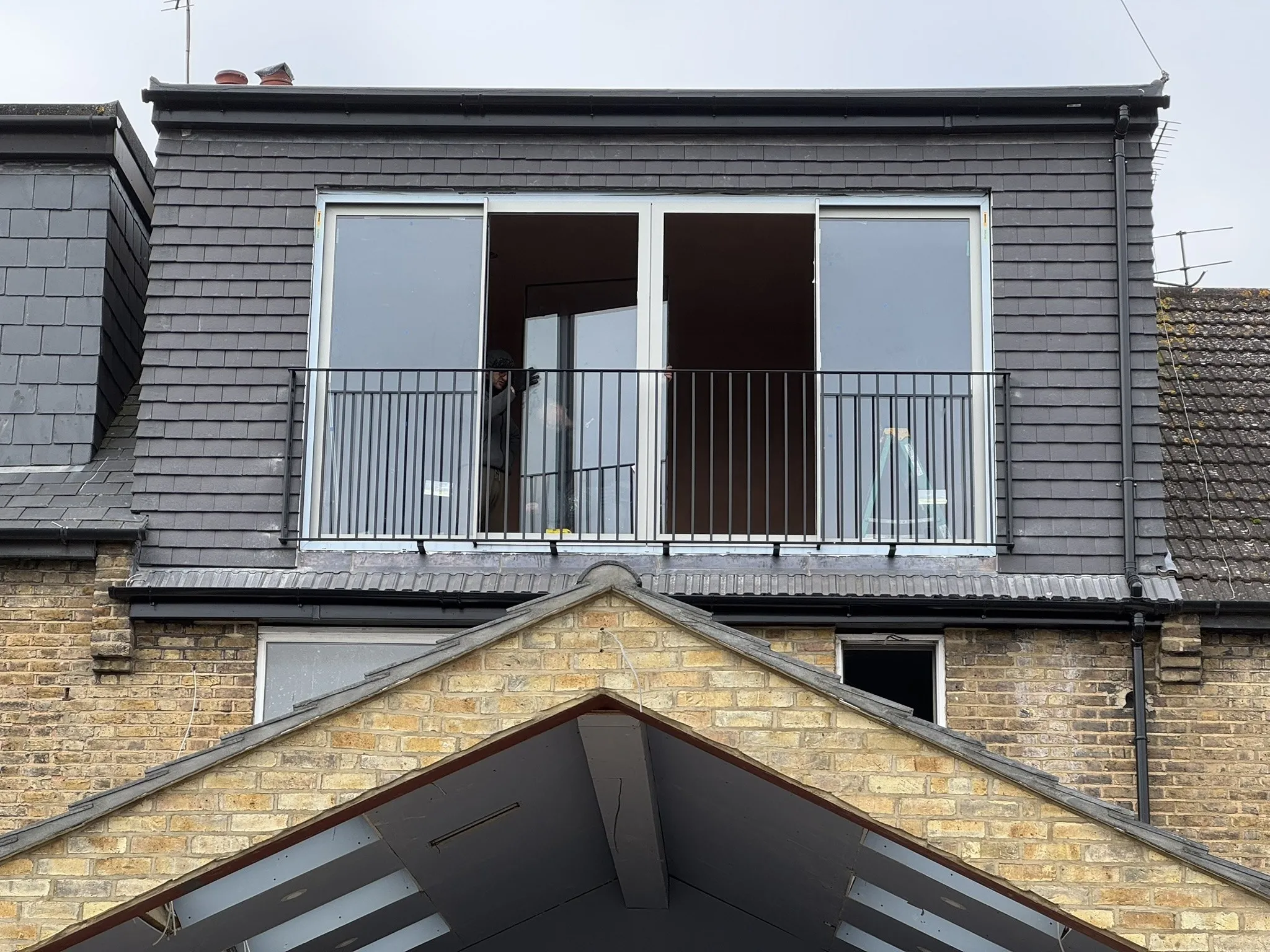 Completed loft extension with dark cladding and a roof terrace
