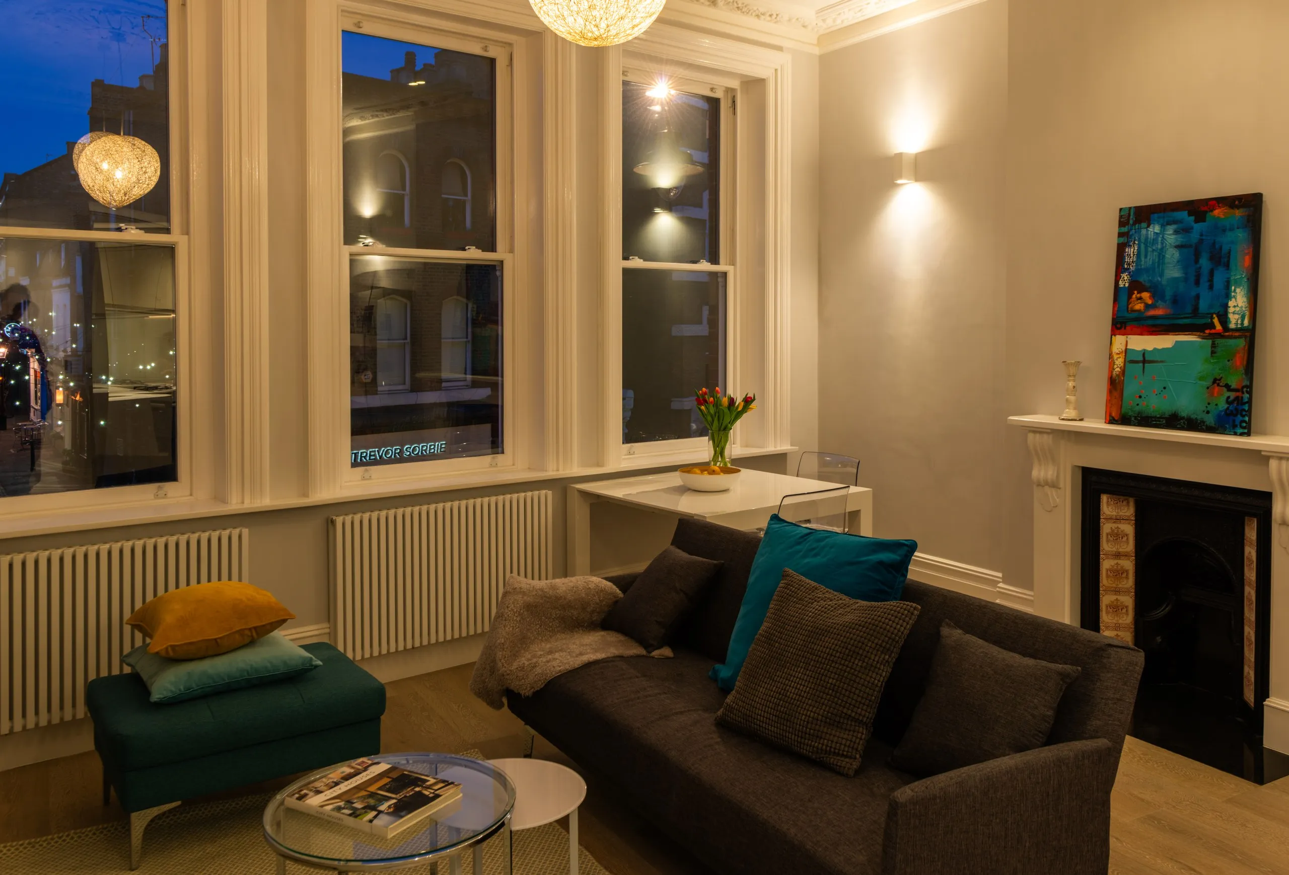 Refurbished Hampstead living room with fitted shelving and warm lighting